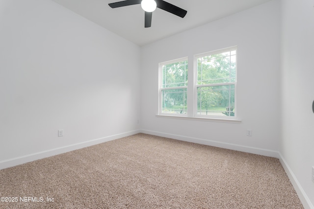 spare room with carpet flooring, a ceiling fan, and baseboards