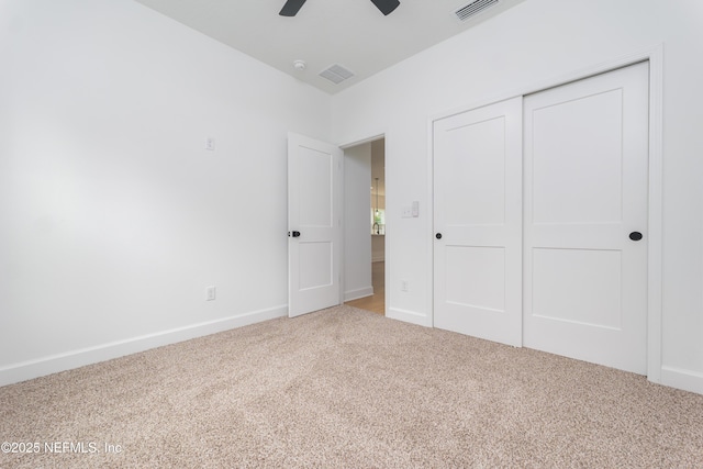 unfurnished bedroom featuring baseboards, a closet, visible vents, and carpet flooring