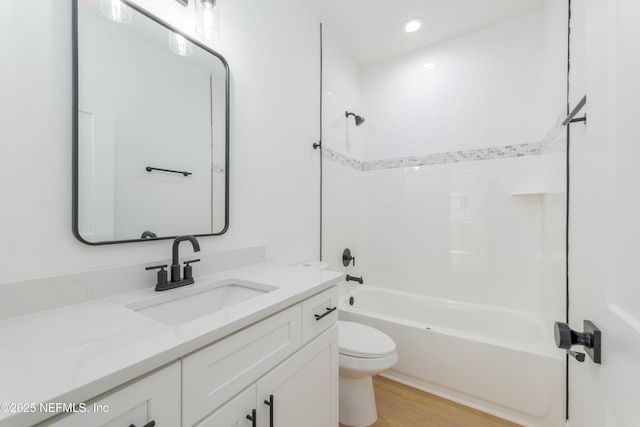 full bath with recessed lighting, shower / bath combination, toilet, vanity, and wood finished floors