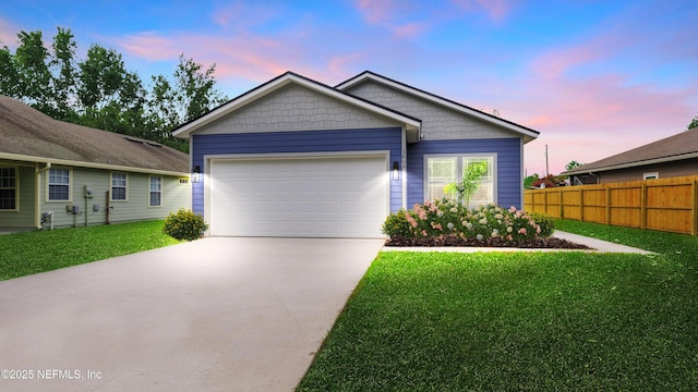 view of front of home featuring concrete driveway, an attached garage, fence, and a front yard