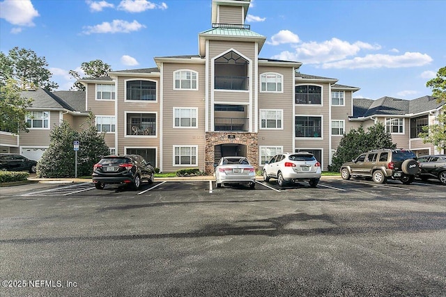 view of property with uncovered parking