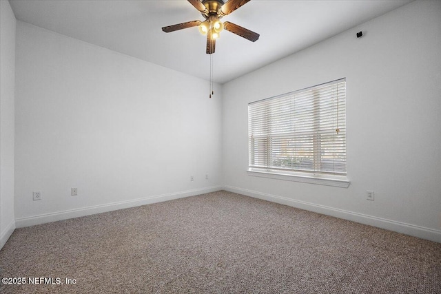 carpeted empty room with ceiling fan and baseboards