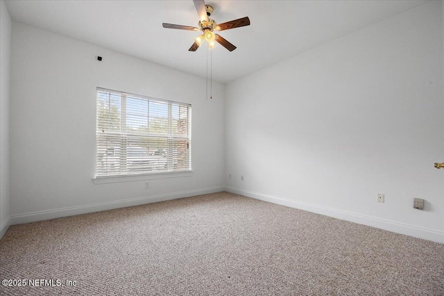 spare room with a ceiling fan, baseboards, and carpet flooring