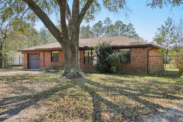 single story home featuring a garage, brick siding, a front lawn, and fence