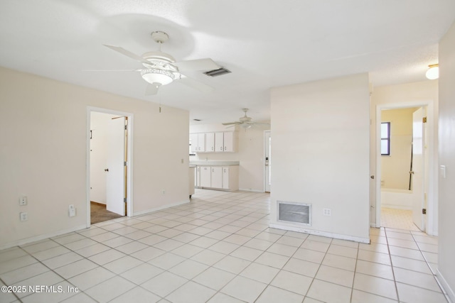 spare room featuring visible vents, ceiling fan, baseboards, and light tile patterned flooring