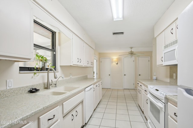 kitchen with ceiling fan, white appliances, a sink, visible vents, and white cabinetry