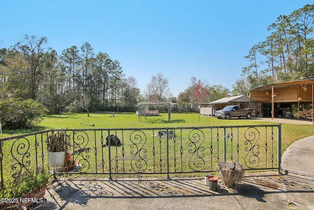 view of gate featuring a yard