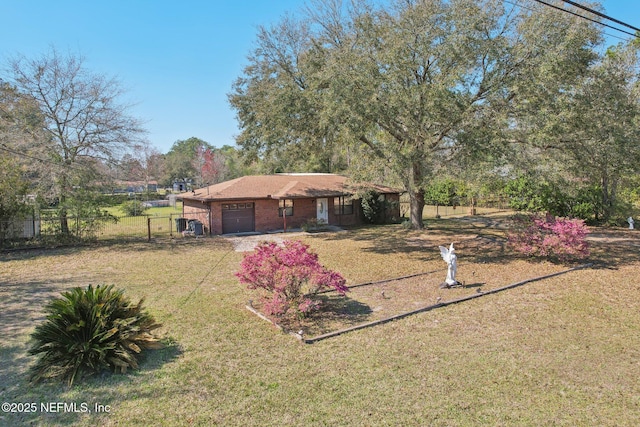 view of front facade featuring a garage, brick siding, a front lawn, and fence