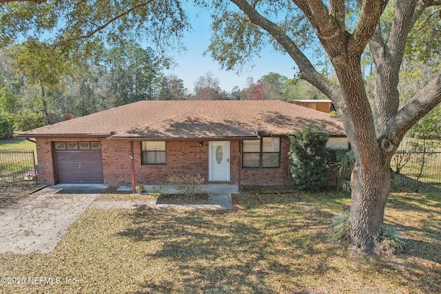 ranch-style house with a garage, driveway, fence, a front lawn, and brick siding