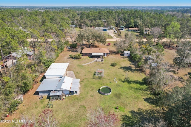 drone / aerial view featuring a wooded view