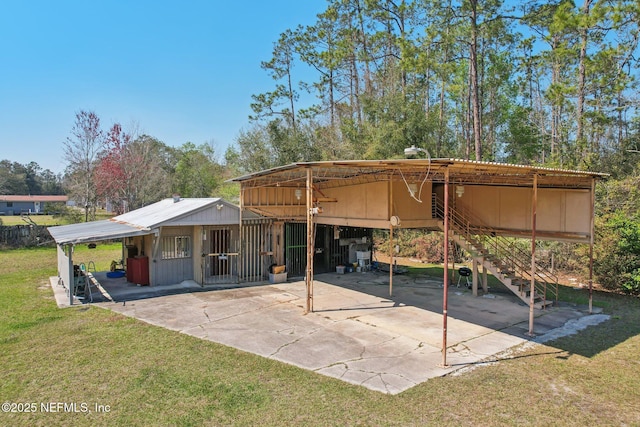 rear view of house with driveway and a lawn