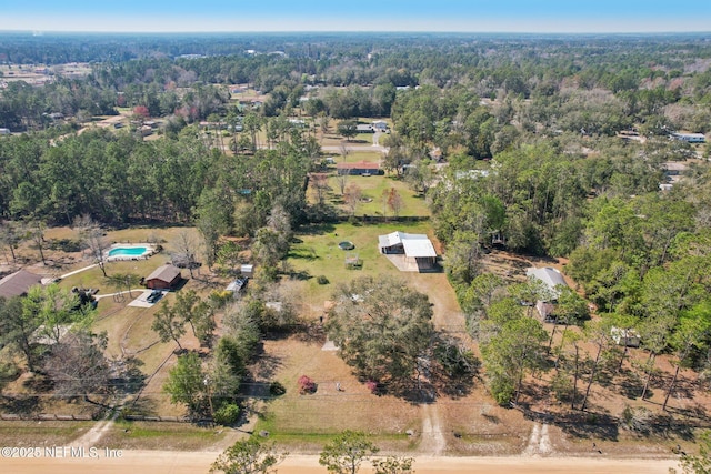 birds eye view of property featuring a wooded view