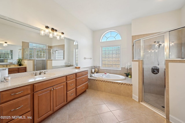 bathroom featuring a healthy amount of sunlight, a stall shower, a garden tub, and tile patterned floors