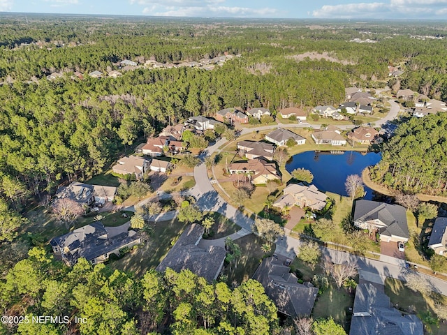 birds eye view of property with a residential view, a water view, and a wooded view