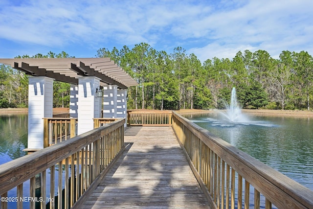 view of home's community with a water view and a pergola