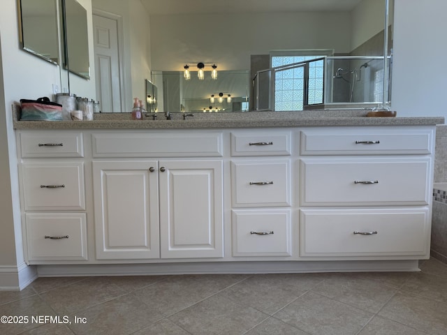243 Stonewell Dr, Saint Johns, FL 32259 - full bathroom featuring a shower stall, double vanity, and tile patterned flooring