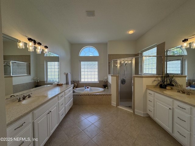243 Stonewell Dr, Saint Johns, FL 32259 - full bath featuring a garden tub, two vanities, a shower stall, and tile patterned flooring