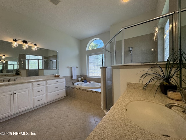 243 Stonewell Dr, Saint Johns, FL 32259 - bathroom with a garden tub, vanity, a shower stall, tile patterned floors, and a textured ceiling