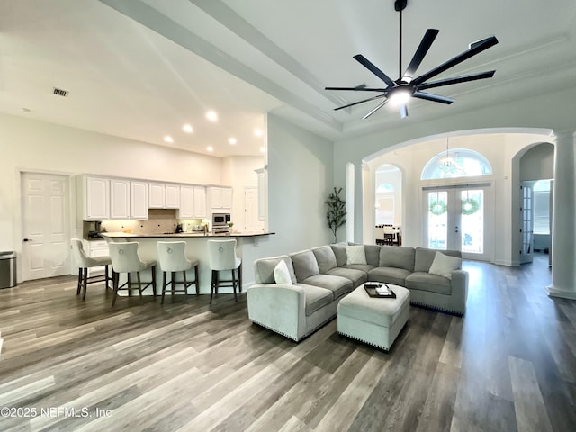243 Stonewell Dr, Saint Johns, FL 32259 - living room with arched walkways, recessed lighting, wood finished floors, a ceiling fan, and french doors