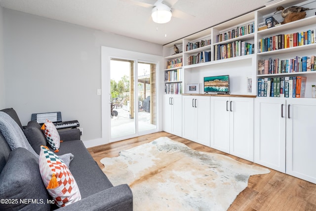 interior space with light wood-style flooring, a ceiling fan, and a textured ceiling