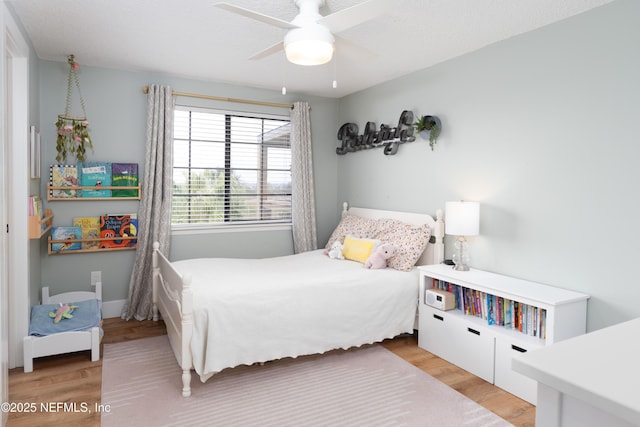 bedroom featuring light wood-style floors and ceiling fan