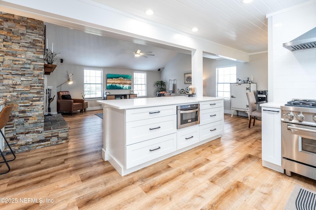 kitchen with white cabinets, appliances with stainless steel finishes, light countertops, and open floor plan