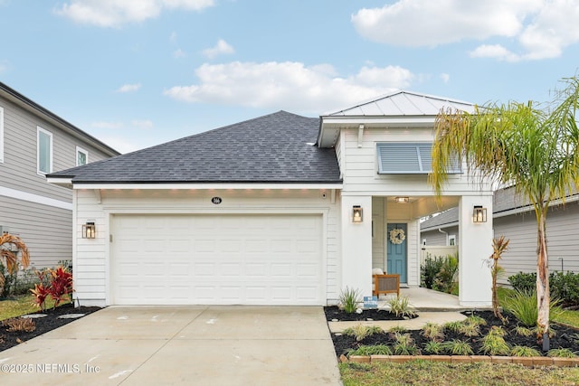 view of front of house featuring a garage, metal roof, a shingled roof, and a standing seam roof