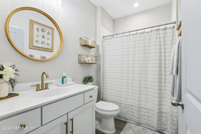 full bath with wood finished floors, a shower with shower curtain, vanity, and toilet