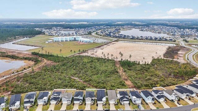 drone / aerial view with a residential view and a water view