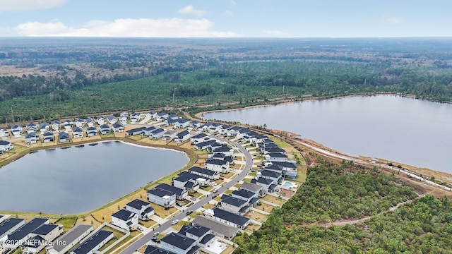 bird's eye view featuring a water view, a residential view, and a view of trees