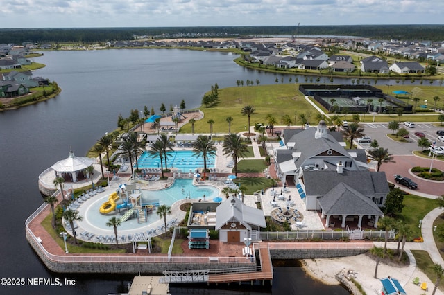 birds eye view of property with a water view and a residential view