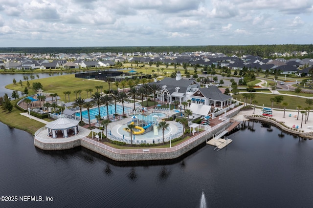 birds eye view of property with a water view and a residential view