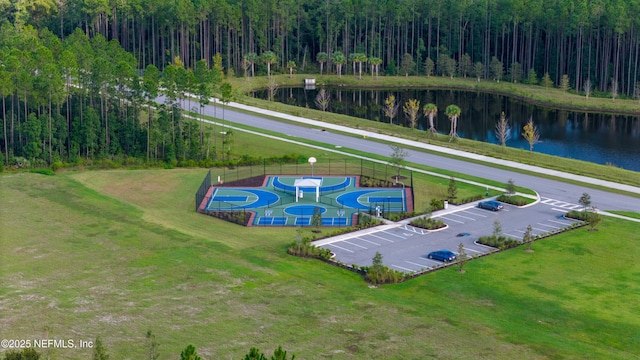 drone / aerial view featuring a water view and a wooded view