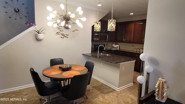 dining space featuring baseboards and a chandelier