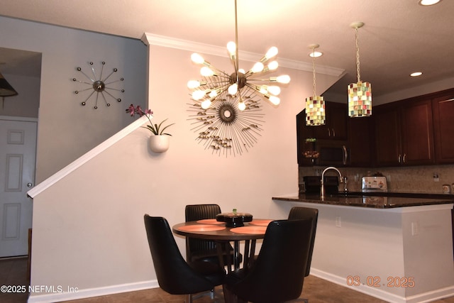 dining space featuring a toaster, a chandelier, and crown molding