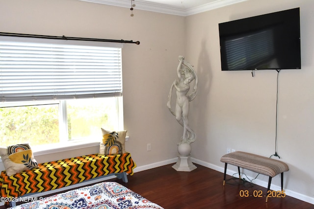 bedroom featuring ornamental molding, wood finished floors, and baseboards