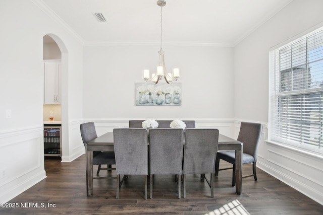 dining area with dark wood-type flooring, beverage cooler, and plenty of natural light