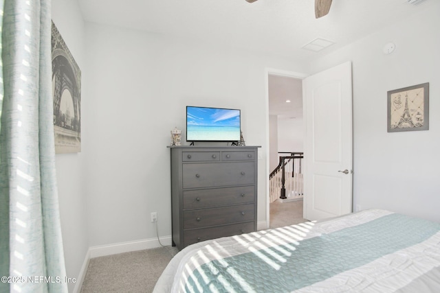 carpeted bedroom with ceiling fan and baseboards