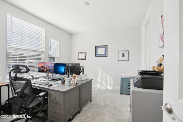 home office featuring light colored carpet and baseboards