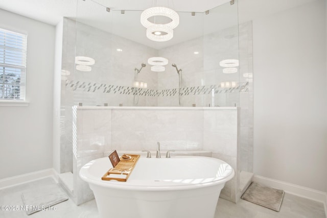 full bath featuring a soaking tub, baseboards, and walk in shower