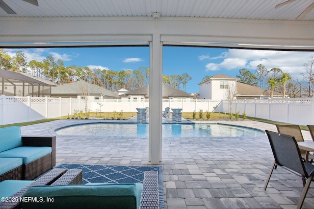 view of swimming pool featuring a fenced in pool, a patio area, and a fenced backyard