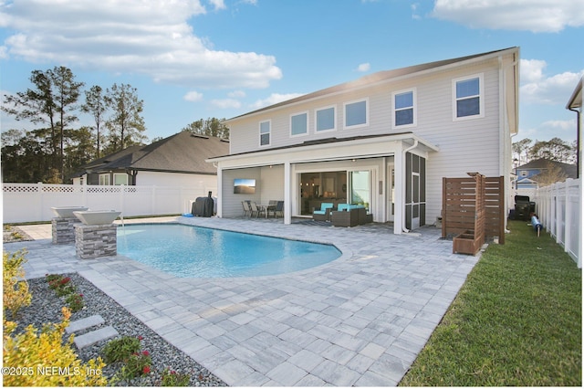 rear view of property with a fenced in pool, a lawn, an outdoor hangout area, a patio area, and a fenced backyard