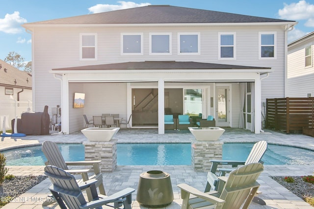 back of house with a patio area, fence, and an outdoor pool