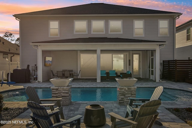 back of house featuring a patio area, fence, and a fenced in pool