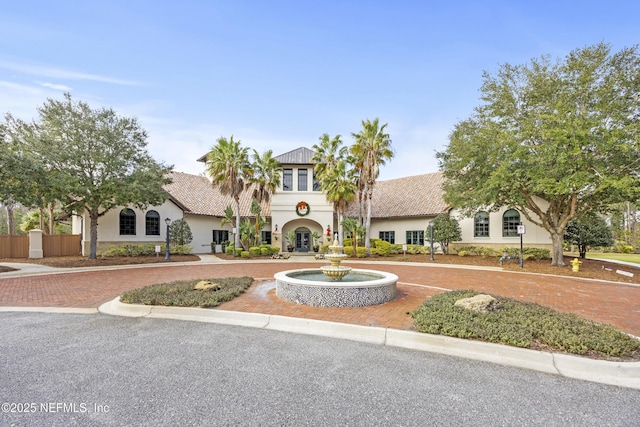 view of front facade with a tile roof and stucco siding