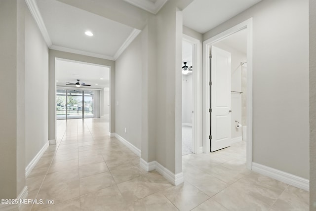 hallway featuring recessed lighting, baseboards, crown molding, and light tile patterned flooring