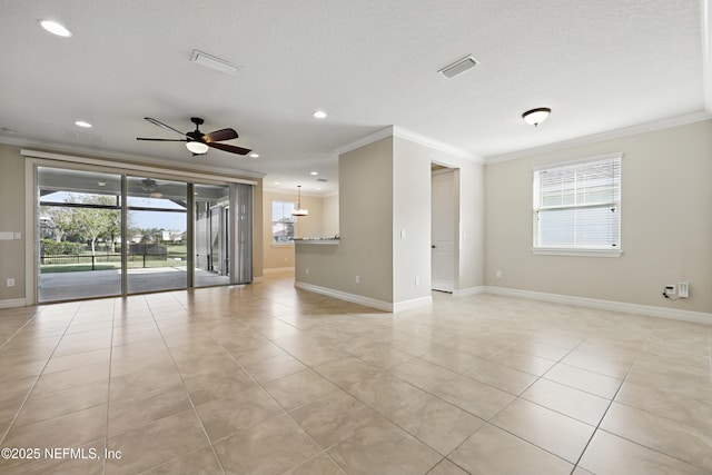 unfurnished room with plenty of natural light, visible vents, and crown molding