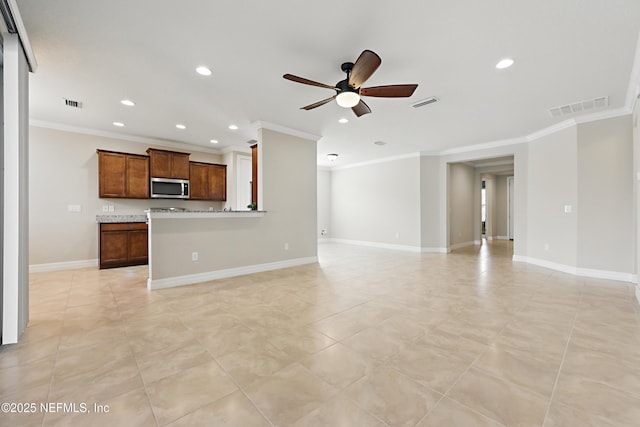 unfurnished living room with baseboards, visible vents, ceiling fan, and crown molding