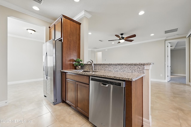 kitchen featuring stainless steel appliances, a sink, visible vents, light stone countertops, and crown molding