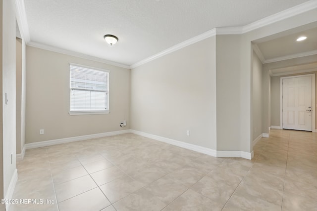 spare room featuring light tile patterned floors, baseboards, ornamental molding, and a textured ceiling